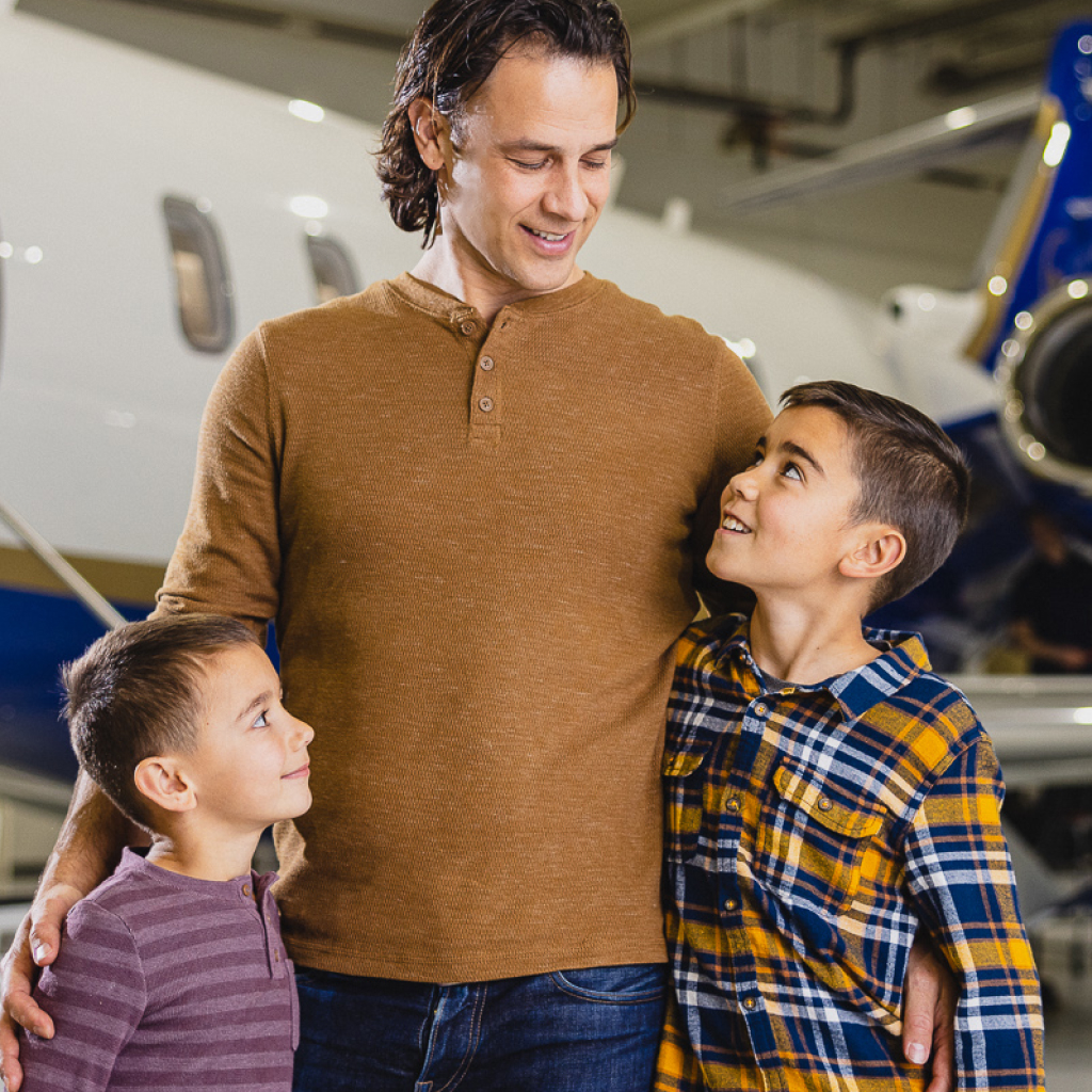 An AirShare employee talking with his children