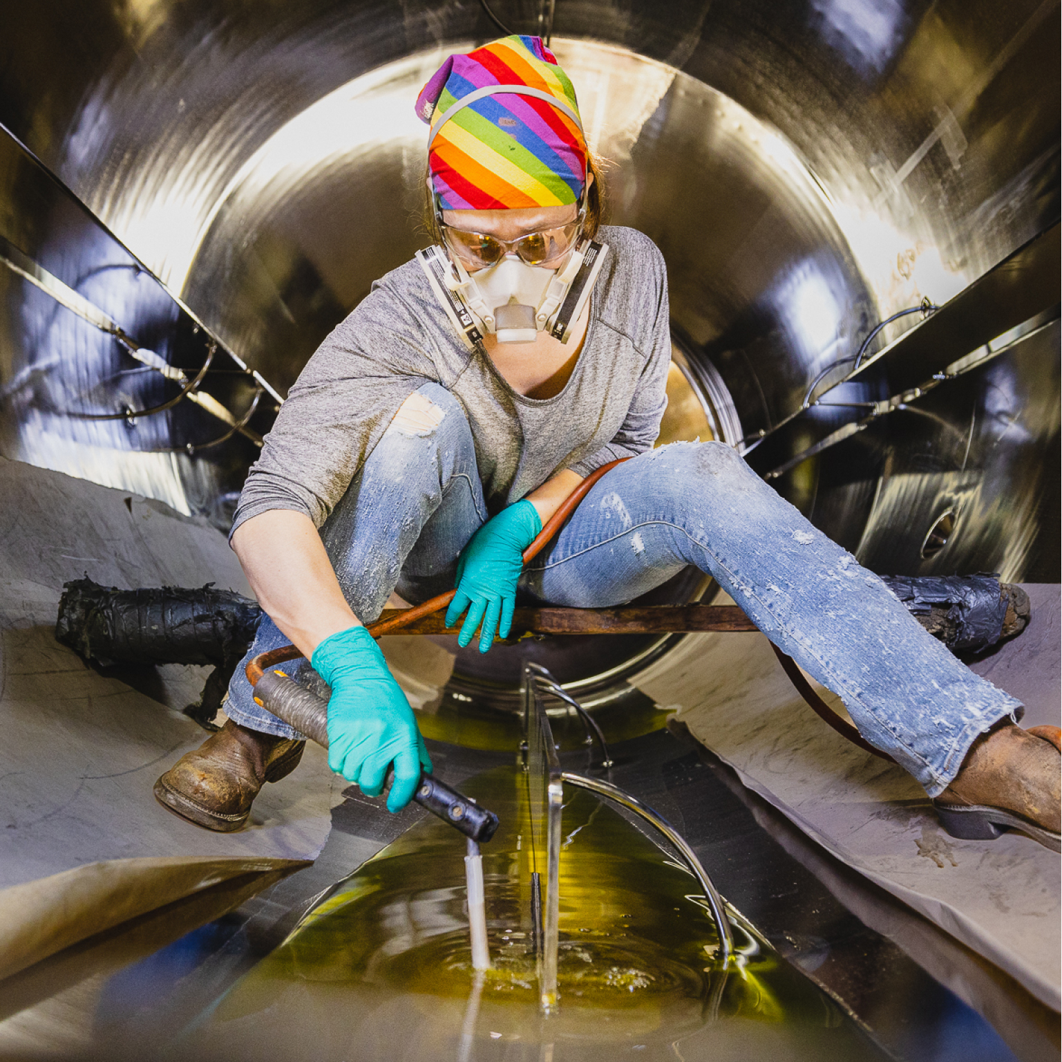 Employee in manufacturing company working on a tank