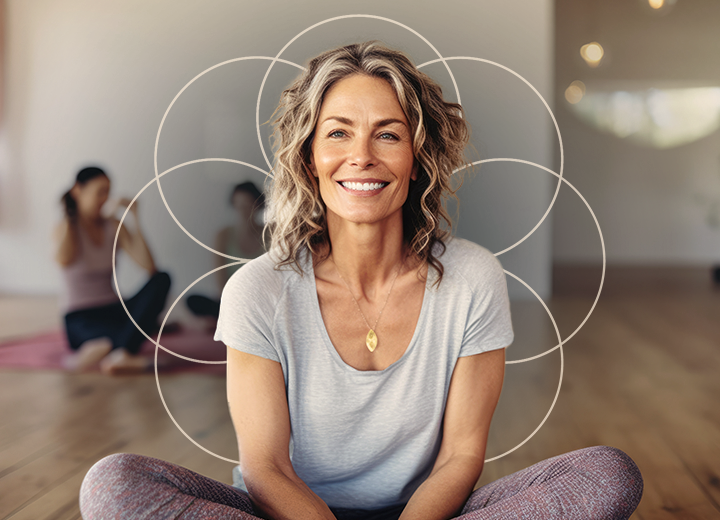 an image of a smiling woman doing yoga with two people in the background